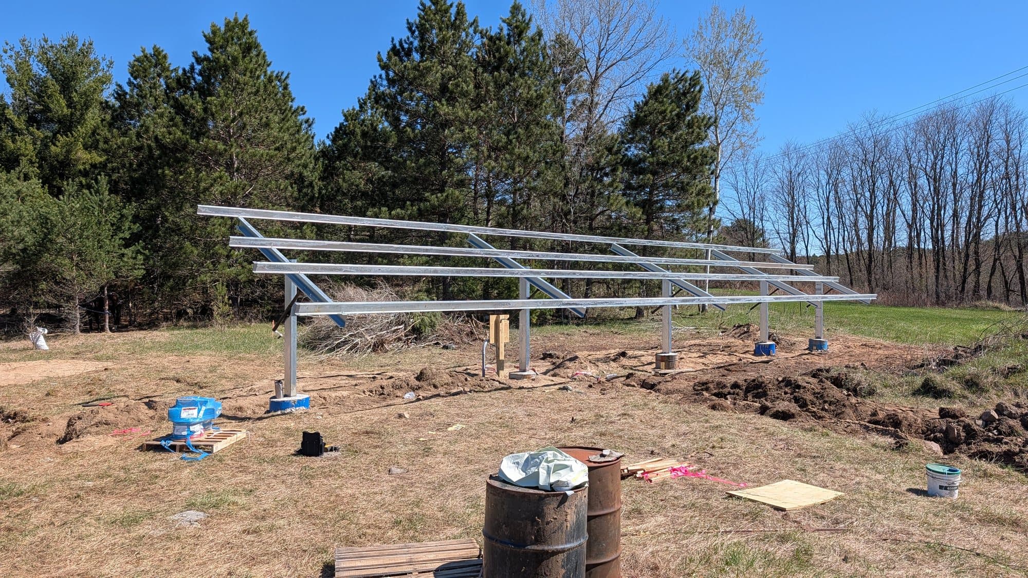 Galvanized ground-mount racking on concrete piers, before the modules went on.
